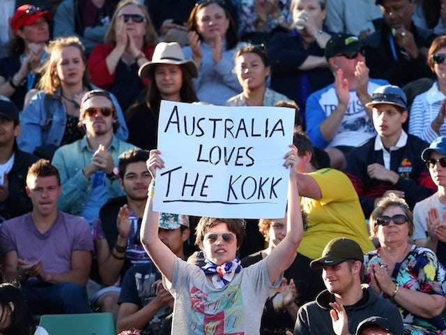 A fan of Thanasi Kokkinakis holds a sign declaring 'Australia Loves The Kokk' during day one of the Australian Open on January 19, 2015