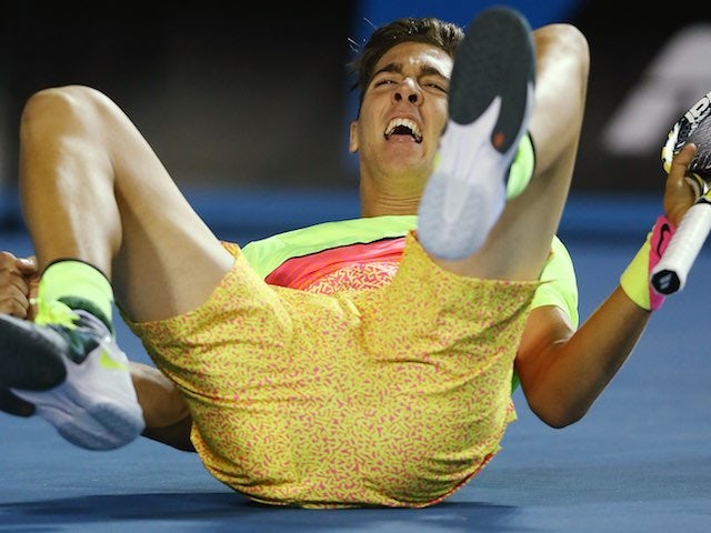 Australia's Thanasi Kokkinakis drops to the ground in disbelief after ousting Ernests Gulbis in the first round of the Australian Open on January 19, 2015