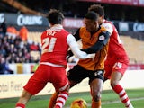 Rajiv van La Parra of Wolverhampton Wanderers is tackled by Morgan Fox and Jordan Cousins of Charlton Athletic during the Sky Bet Championship match between Wolverhampton Wanderers and Charlton Athletic at Molineux on January 24, 2015