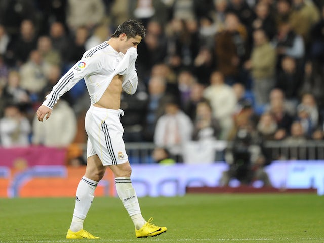 Real Madrid's Portuguese forward Cristiano Ronaldo leaves the field after receiving a red card playing Malaga during their Spanish League football match on January 24, 2010