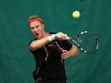 Dominic Inglot of Great Britain in action against Farrukh Dustov of Uzbekistan on the indoor courts during a qualifying match ahead of the AEGON Championships at Queens Club on June 7, 2014