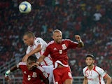 Equatorial Guinea's defender Diosdado Mbele and Equatorial Guinea's midfielder Randy head the ball with Tunisia's forward Ahmed Akaichi during the 2015 African Cup of Nations quarter-final football match between Equatorial Guinea and Tunisia in Bata on Ja