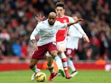 Fabian Delph of Aston Villa is challenged by Hector Bellerin of Arsenal during the Barclays Premier League match on February 1, 2015