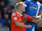 Harry Davis of Crewe Alexander challenges Tyrone Barnett of Peterborough United during their Sky Bet League One match at the Alexandra Stadium on September 7, 2013