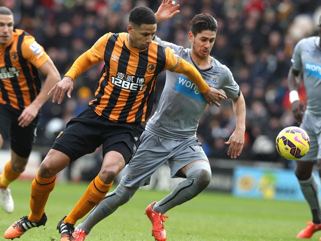 Hull City's English defender Curtis Davies challenges Newcastle United's Spanish striker Ayoze Perez during the English Premier League football match between Hull City and Newcastle United at the KC Stadium in Hull, Northern England, on January 31, 2015