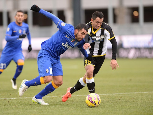 Ivan Piris (R) of Udinese Calcio competes with Carlos Tevez of Juventus FC during the Serie A match at Stadio Friuli on February 1, 2015