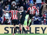 Jermain Defoe (R) celebrates after scoring his team's second goal during the English Premier League football match against Burnley on January 31, 2015