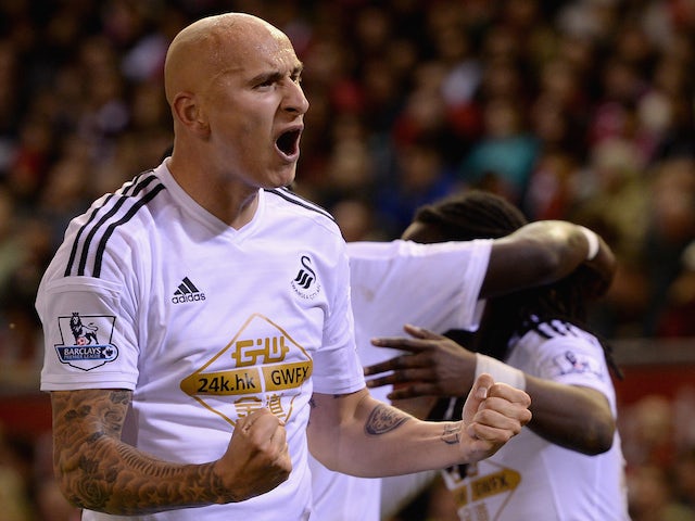 Jonjo Shelvey of Swansea celebrates Marvin Emnes's opening goal during the Capital One Cup Fourth Round match against Liverpool on October 28, 2014