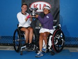 Yui Kamiji of Japan and Jordanne Whiley of Great Britain pose with the winners trophy after winning their women's wheelchair doubles final match against Jiske Griffioen of the Netherlands and Aniel Van Koot of the Netherlands during the Australian Open 20