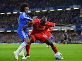Liverpool's French defender Mamadou Sakho (R) battles with Chelsea's Brazilian midfielder Willian (L) during the English League Cup semi-final second leg football match on January 27, 2015