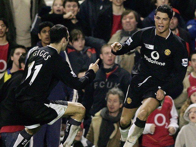 Cristiano Ronaldo of Manchester United is congratulated by Ryan Giggs after scoring their second goal of the game during the Barclays Premiership match between Arsenal and Manchester United at Highbury on February 1, 2005