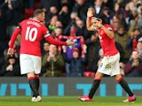Radamel Falcao of Manchester United celebrates with teammate Wayne Rooney (L) of Manchester United after scoring his team's second goal during the Barclays Premier League match between Manchester United and Leicester City at Old Trafford on January 31, 20