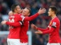 Robin van Persie of Manchester United is congratulated by teammates Wayne Rooney and Adnan Januzaj after scoring his team's first goal during the Barclays Premier League match between Manchester United and Leicester City at Old Trafford on January 31, 201