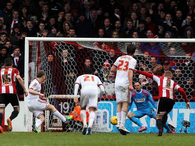 Grant Leadbitter of Middlesbrough scores from the penalty spot past David Button the Brentford goalkeeper during the Sky Bet Championship match between Brentford and Middlesbrough at Griffin Park on January 31, 2015
