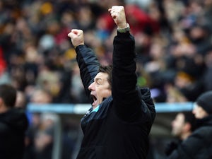 John Carver, manager of Newcastle United celebrates his team's third goal during the Barclays Premier League match between Hull City and Newcastle United at KC Stadium on January 31, 2015