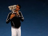 Novak Djokovic of Serbia poses with the Norman Brookes Challenge Cup after winning the men's final match against Rafael Nadal of Spain during day fourteen of the 2012 Australian Open at Melbourne Park on January 29, 2012