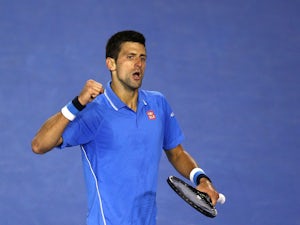 Djokovic holds off Isner challenge