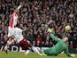 Arsenal's French striker Olivier Giroud (L) lifts the ball over Aston Villa's US goalkeeper Brad Guzan (R) to score the opening goal during the English Premier League football match on February 1, 2015