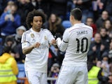 Real Madrid's Colombian midfielder James Rodriguez celebrates with Real Madrid's Brazilian defender Marcelo during the Spanish league football match Real Madrid CF vs Real Sociedad de Futbol at the Santiago Bernabeu stadium in Madrid on January 31, 2015