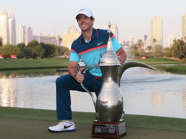 Rory McIlroy of Northern Ireland poses with the winners trophy after winning the final round of the 2015 Omega Dubai Desert Classic on February 1, 2015