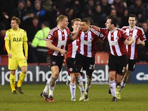 Che Adams of Sheffield United celebrates scoring his second goal with team mates during the Capital One Cup Semi-Final Second Leg match between Sheffield United and Tottenham Hotspur at Bramall Lane on January 28, 2015