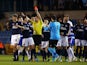 Sid Nelson of Millwall (R) is shown a red card by referee Andrew Madley after he puts a late tackle in on Reading's Nick Blackman during the Sky Bet Championship match on January 27, 2015