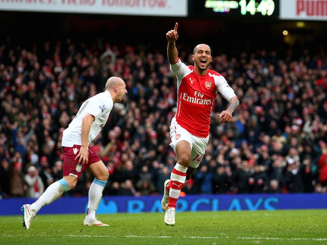 Theo Walcott of Arsenal celebrates after scoring his team's third goal during the Barclays Premier League match against Aston Villa on February 1, 2015