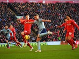 Kevin Nolan of West Ham United shoots as he is closed down by Martin Skrtel of Liverpool during the Barclays Premier League match between Liverpool and West Ham United at Anfield on January 31, 2015