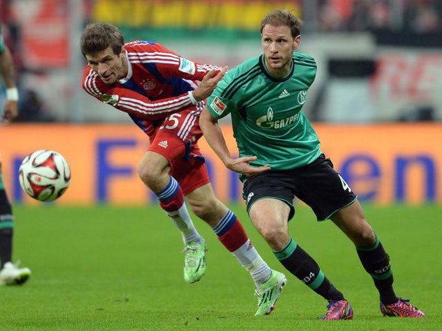Bayern Munich's striker Thomas Muller and Schalke's defender Benedikt Howedes vie for the ball during the German first division Bundesliga football match FC Bayern Munich vs FC Schalke 04 at the Allianz Arena in Munich, southern Germany, on February 3, 20