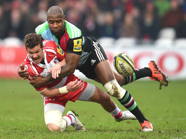 Billy Burns of Gloucester and Ugo Monye of Harlequins battle for the ball during the LV=Cup match on February 7, 2015