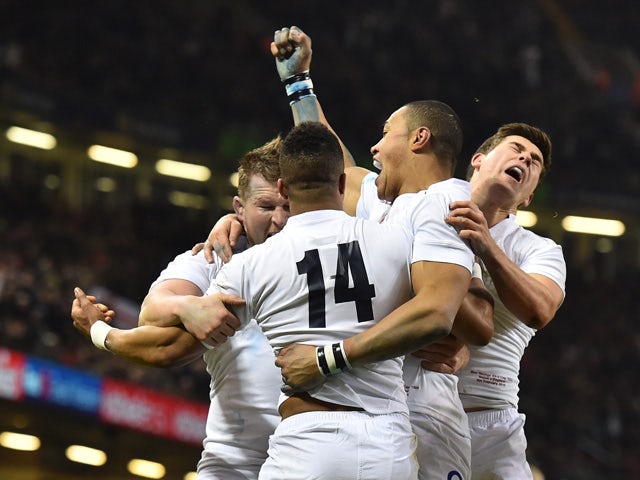 England's wing Anthony Watson celebrates with team-mates after scoring a try during the Six Nations international rugby union match between Wales and England at the Millennium Stadium in Cardiff, south Wales, on February 6, 2015
