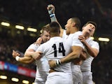 England's wing Anthony Watson celebrates with team-mates after scoring a try during the Six Nations international rugby union match between Wales and England at the Millennium Stadium in Cardiff, south Wales, on February 6, 2015