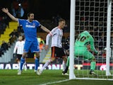 Marcus Bettinelli of Fulham fumbles the ball in to his own net for Sunderland's opening goal as John O'Shea of Sunderland celebrates during the FA Cup Fourth Round Replay match between Fulham and Sunderland at Craven Cottage on February 3, 2015