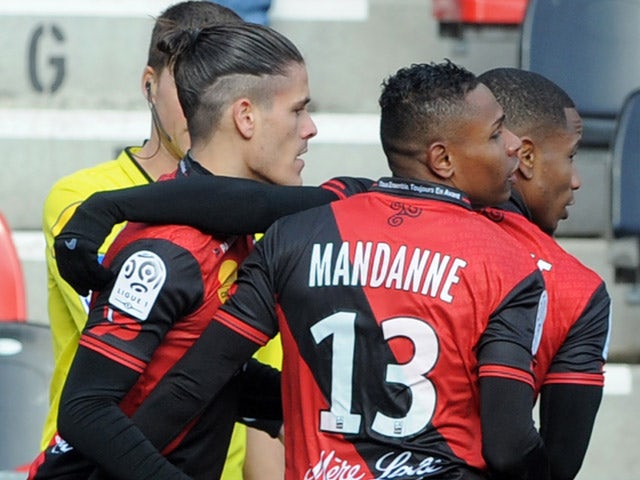 Guingamp's French defender Dorian Leveque is congratulated by his teammates after scoring during the French L1 football match Guingamp vs Monaco on February 8, 2015