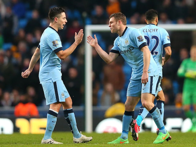 James Milner (R) of Manchester City celebrates scoring the equalising goal with team-mate Samir Nasri during the Barclays Premier League match against Hull on February 7, 2015