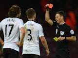 Referee Mark Clattenburg shows Luke Shaw of Manchester United a red card during the Barclays Premier League match against West Ham United on February 8, 2015
