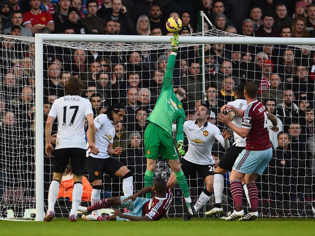 David De Gea of Manchester United makes a save from Enner Valencia of West Ham during the Barclays Premier League match between West Ham United and Manchester United at Boleyn Ground on February 8, 2015