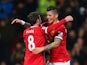 Juan Mata of Manchester United congratulates Marcos Rojo of Manchester United on scoring their second goal during the FA Cup Fourth round replay match between Manchester United and Cambridge United at Old Trafford on February 3, 2015