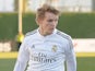 Martin Odegaard of Real Madrid Castilla takes on two Athletic Club B players during the Segunda Division B match against Athletic Club B on February 8, 2015