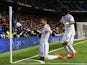 Real Madrid's Colombian midfielder James Rodriguez celebrates past Real Madrid's Brazilian defender Marcelo after scoring during the Spanish league football match Real Madrid CF vs Sevilla FC at the Santiago Bernabeu stadium in Madrid on February 4, 2015