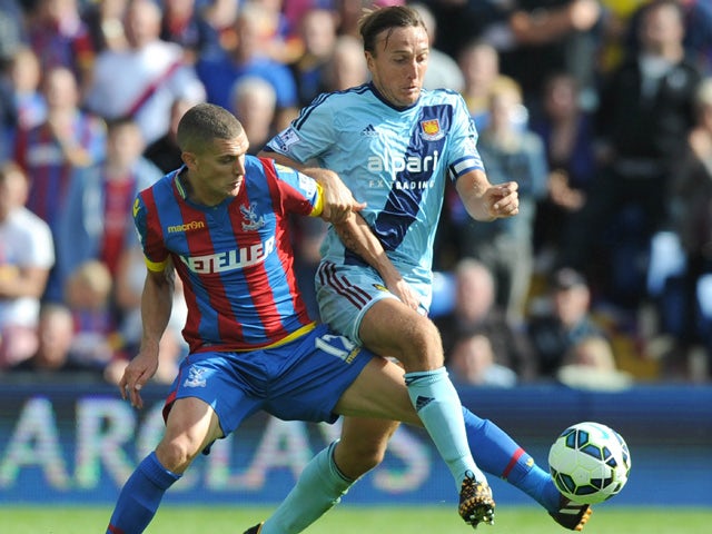Crystal Palace's English midfielder Stuart OKeefe vies with West Ham United's English midfielder Mark Noble (R) during the English Premier League football match between Crystal Palace and West Ham United at Selhurst Park in south London on August 23, 2014