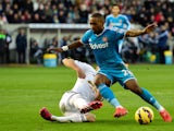 Sunderland player Jermain Defoe is challenged by Federico Fernandez of Swansea during the Barclays Premier League match between Swansea City and Sunderland at Liberty Stadium on February 7, 2015
