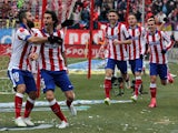 Atletico Madrid's Portuguese midfielder Tiago (2ndL) celebrates with teammates after scoring during the Spanish league football match against Real Madrid on February 7, 2015