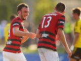 Mark Bridge and Matthew Spiranovic of the Wanderers celebrate at full time following the round 16 A-League match between the Western Sydney Wanderers and the Wellington Phoenix at Sportingbet Stadium on February 8, 2015