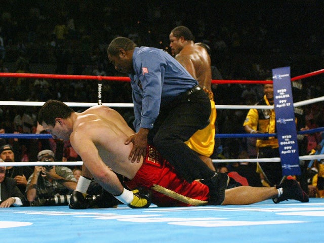  Referee Robert Byrd helps Wladimir Klitschko to his feet after Lamon Brewster knocked him down in the fifth round during a fight for the WBO World Heavyweight Championship on April 10, 2004
