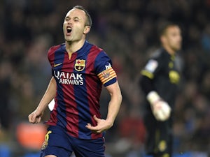 Barcelona's midfielder Andres Iniesta celebrates after scoring a goal during the Spanish Copa del Rey (King's Cup) semifinal first leg football match against Villarreal on February 11, 2015