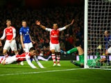 Laurent Koscielny of Arsenal falls after scoring the opening goal during the Barclays Premier League match between Arsenal and Leicester City at Emirates Stadium on February 10, 2015