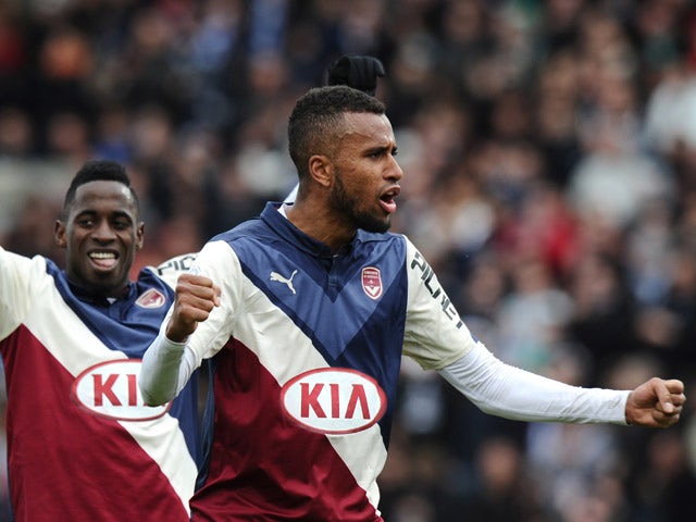 Bordeaux's Swedish forward Isaac Kiese Thelinand Bordeaux's Gabonese midfielder Andre Biyogo Poko celebrate at the end of the French L1 football match between Girondins de Bordeaux (FCGB) and Saint-Etienne (ASSE) on February 15, 2015