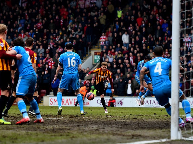 Billy Clarke of Bradford shoots at goal before his shot defelcts off John O'Shea of Sunderland and into his own net for the opening goal during the FA Cup Fifth Round match between Bradford City and Sunderland at Coral Windows Stadium, Valley Parade on Fe