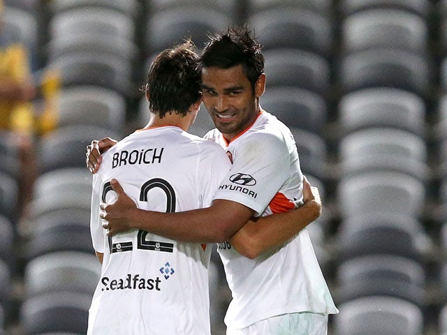Jean Carlos Solorzano celebrates a goal with Thomas Broich of the Roar during the round 17 A-League match between the Central Coast Mariners and the Brisbane Roar at Central Coast Stadium on February 13, 2015